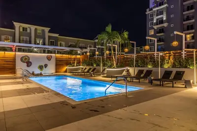 a swimming pool at night in a hotel at Marbella Lane - Panoramic Splendid Ocean Views in Long Beach