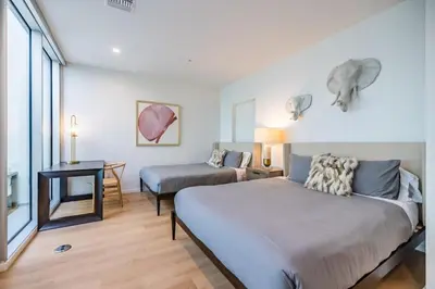 a bedroom with a bed and a desk and a bed sidx sidx sidx at Marbella Lane - Luxurious 3BR Penthouse in Long Beach