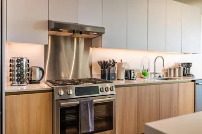 a kitchen with a stove top oven next to a sink at Marbella Lane - Luxurious 3BR Penthouse in Long Beach
