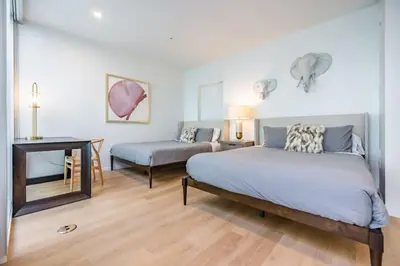 a bedroom with a bed and a table and a desk at Marbella Lane - Luxurious 3BR Penthouse in Long Beach