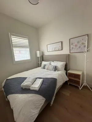 a bedroom with a large bed and a window at Marbella Lane - Lovely DWNTN Getaway LongBeach in Long Beach