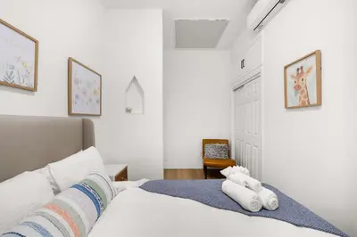 a bedroom with a bed with towels on it at Marbella Lane - Cityside Haven w Touch of Charm in Compton