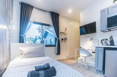 a bedroom with a bed and a desk and a window at Cozy Private Studio, Private Entry in USC DPS Zone - DQA6 in Los Angeles