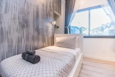 a small bedroom with a bed and a window at Cozy Private Studio, Private Entry in USC DPS Zone - DQA6 in Los Angeles