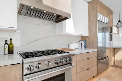 a kitchen with a stainless steel stove top oven at Moonstone Beach House Oceanview Luxe Retreat in Manhattan Beach