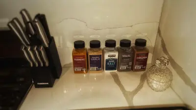 a group of four bottles of honey sitting on a counter at Cozy Cabin Retreat with a Hot Tub in Running Springs