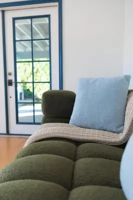 a couch with a pillow sitting in a living room at Cozy Private 1BR Near LAX & SoFi, Pet-Friendly in Los Angeles