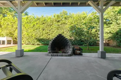 a patio with a stone fireplace under a pavilion at Cozy Private 1BR Near LAX & SoFi, Pet-Friendly in Los Angeles