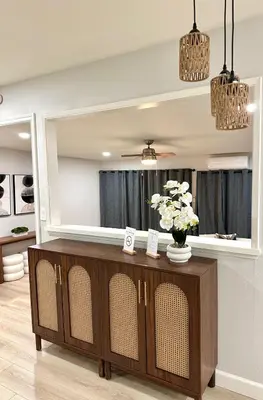 a living room with a large mirror on the wall at The Mills Retreat in Whittier Near Disney in Whittier