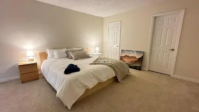 a bedroom with a large bed with white sheets at Cozy stay by Anatolian in Los Angeles