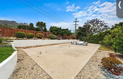 a yard with a concrete driveway with a fence at Ocean View Luxury 5BR Modern Coastal Home in Rancho Palos Verdes