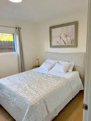 a white bed in a bedroom with a window at Ocean View Luxury 5BR Modern Coastal Home in Rancho Palos Verdes