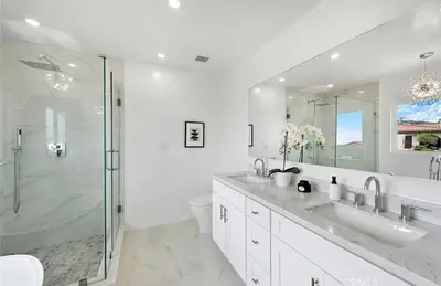 a white bathroom with two sinks and a shower at Ocean View Luxury 5BR Modern Coastal Home in Rancho Palos Verdes