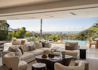 a living room with a couch and a table at Stradella Mansion in Los Angeles