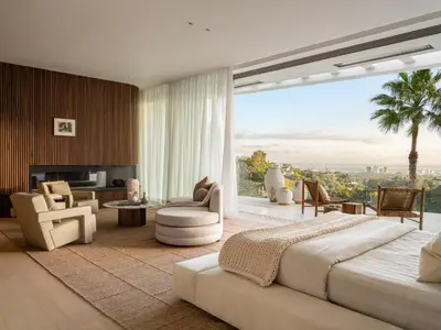 a bedroom with a large bed and a living room at Stradella Mansion in Los Angeles