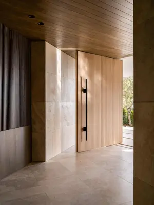 a hallway with a wooden door in a building at Stradella Mansion in Los Angeles