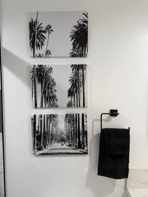 a framed picture of palm trees on a wall at Comfortable & Quaint Room in a Shared Space in Van Nuys
