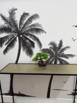 a table with two palm trees on a wall at Comfortable & Quaint Room in a Shared Space in Van Nuys