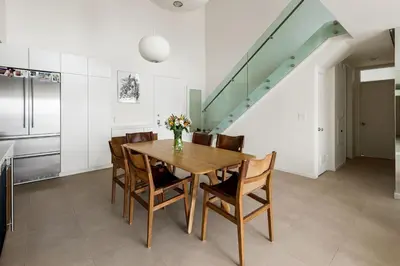 a dining room with a wooden table and chairs at Northstar Premium Ocean Penthouse in Los Angeles