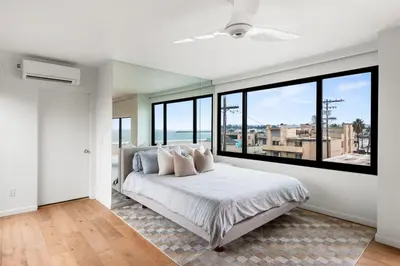 a bedroom with a large bed and large windows at Northstar Premium Ocean Penthouse in Los Angeles