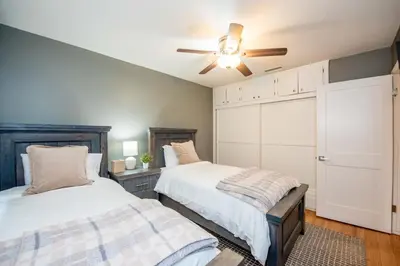 a bedroom with two beds and a ceiling fan at Welcome to your home at the Orange Circle in Orange