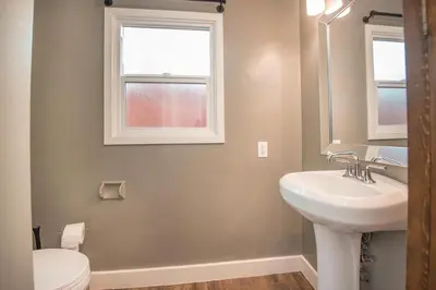 a bathroom with a sink and a toilet and a window at Welcome to your home at the Orange Circle in Orange