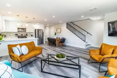 a living room with two couches and a table at Escape in Modern 4BR Home Sleeps 10 with Parking in Burbank