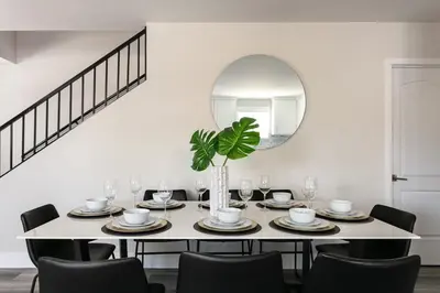 a dining room with a table and a mirror at Spacious Home Central Area Airport Free Parking in Burbank