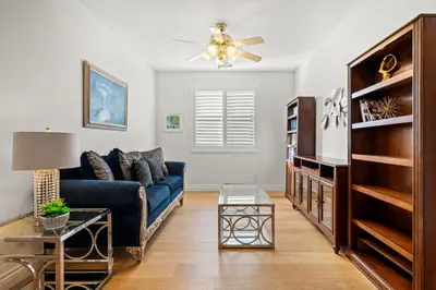 a living room with a blue couch and a ceiling fan at Luxury Hilltop Home Spacious Private Backyard in Rowland Heights