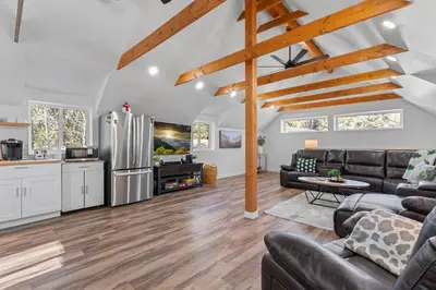 a kitchen and living room with a couch and a table at Tall Pines Retreat Large Patio w BBQ and Firepit! in Big Bear City Airport