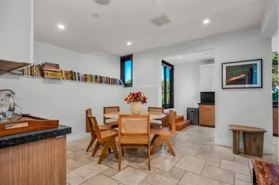 a kitchen and dining room with a table and chairs at Ridpath Retreat Guest House in Los Angeles