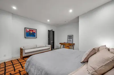 a bedroom with a bed and a couch and a chair at Ridpath Retreat Guest House in Los Angeles