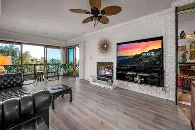 a living room with a fireplace and a tv at Secret Stairs Family in Los Angeles