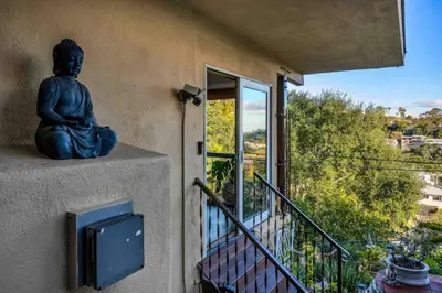a statue sitting on the side of a house at Secret Stairs Family in Los Angeles