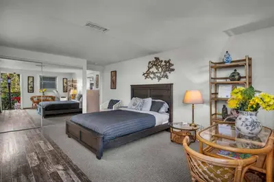 a bedroom with a bed and a living room at Secret Stairs Family in Los Angeles