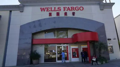people standing outside of a wells fargo building at \u963f\u5c14\u7f55\u5e03\u62c9\u6c11\u5bbf in Alhambra
