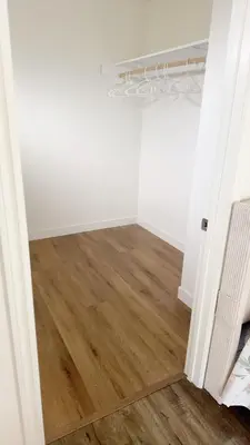 an empty room with a wooden floor and a closet at Huge bedroom with shared bathroom in Ontario