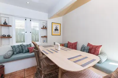 a dining room with a wooden table and chairs at Lush Venice Beach Oasis Home -just steps to beach in Los Angeles
