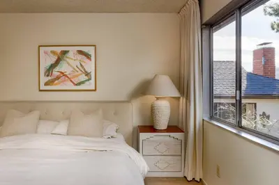 a bedroom with a bed and a large window at NEW Vintage Canyon Retreat in Mount Washington in Los Angeles