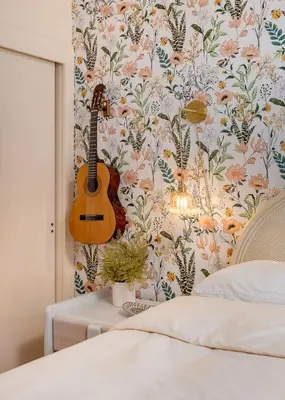 a guitar hanging on a wall next to a bed at NEW Vintage Canyon Retreat in Mount Washington in Los Angeles