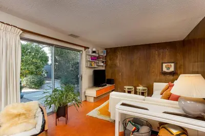 a living room with a white couch and a large window at NEW Vintage Canyon Retreat in Mount Washington in Los Angeles