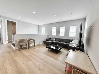 a living room with a couch and a table at Marbella Lane Spacious 4BR Modern Family Home in Placentia
