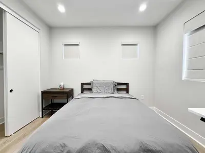 a bedroom with a large bed in a white wall at Marbella Lane Spacious 4BR Modern Family Home in Placentia