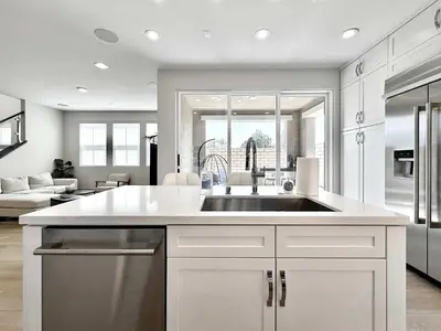 a kitchen with a sink and a living room at Marbella Lane Spacious 4BR Modern Family Home in Placentia