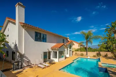 a house with a swimming pool in front of it at Marbella Lane - Captivating Home w Pool in Rowland Heights