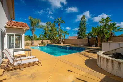 a patio with two chairs and a swimming pool at Marbella Lane - Revitalizing Getaway w Pool in Rowland Heights