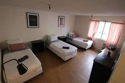 a hotel room with two beds and a couch at 3 beds Apart in Beverly Hills Neighborhood in Los Angeles