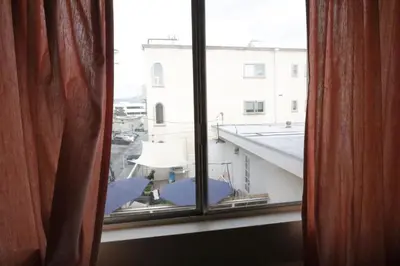 a view of a window with an umbrella at 3 beds Apart in Beverly Hills Neighborhood in Los Angeles