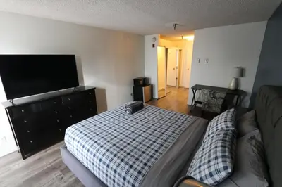 a bedroom with a bed and a flat screen tv at Nice Queed bed apt in Beverly Hills neighborhood in Los Angeles