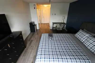 a bedroom with a bed and a dresser and a door at Nice Queed bed apt in Beverly Hills neighborhood in Los Angeles